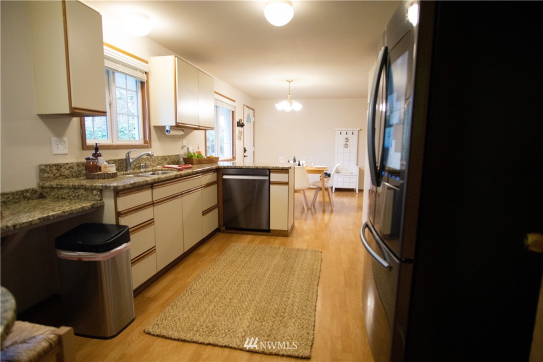 306 216th Street Southwest Bothell, WA 98021 - Photo 7 of 31 a kitchen with stainless steel appliances granite countertop sink stove and refrigerator