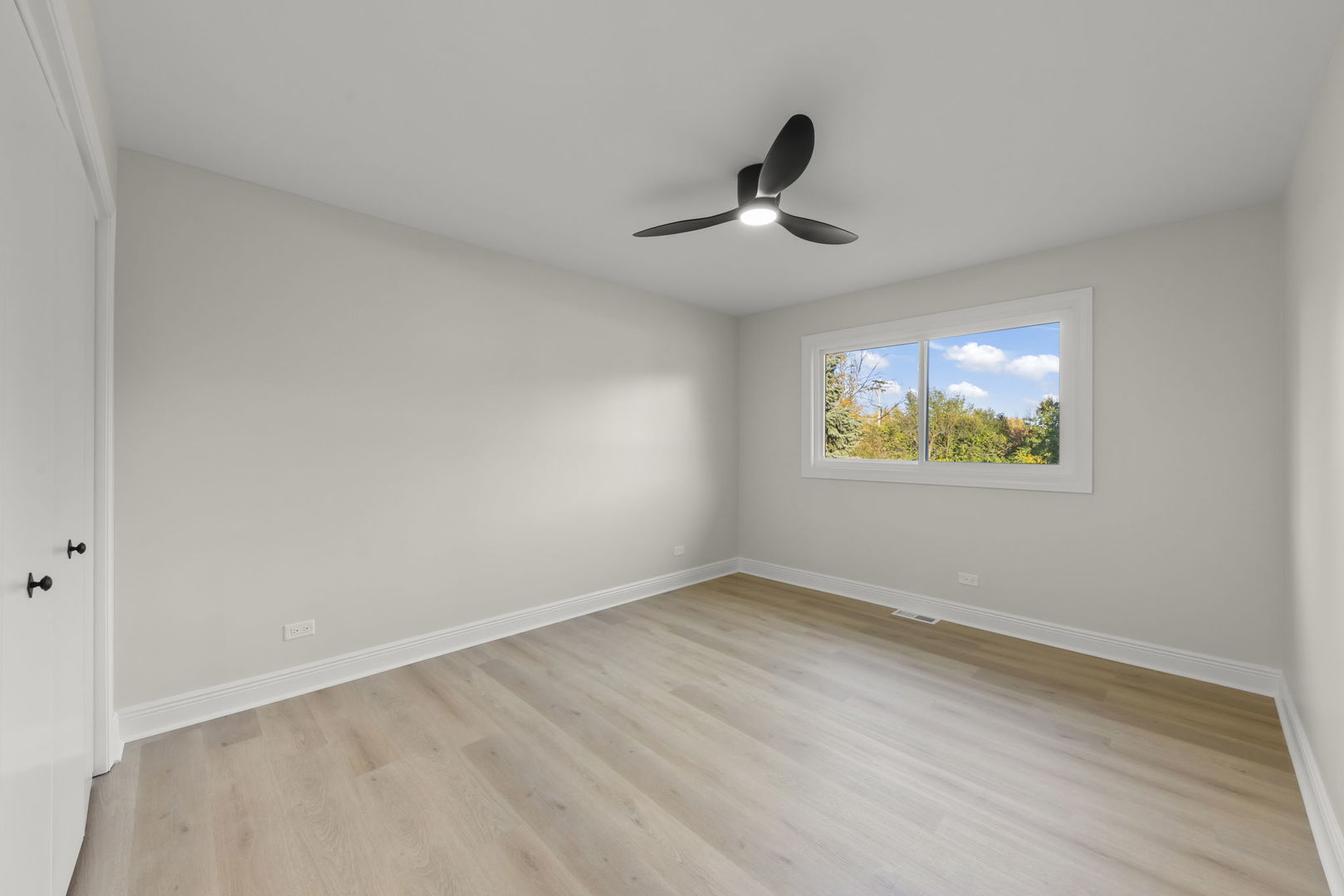 641 Highview Avenue Addison, IL 60101 - Photo 13 of 36 a view of an empty room with wooden floor and a window