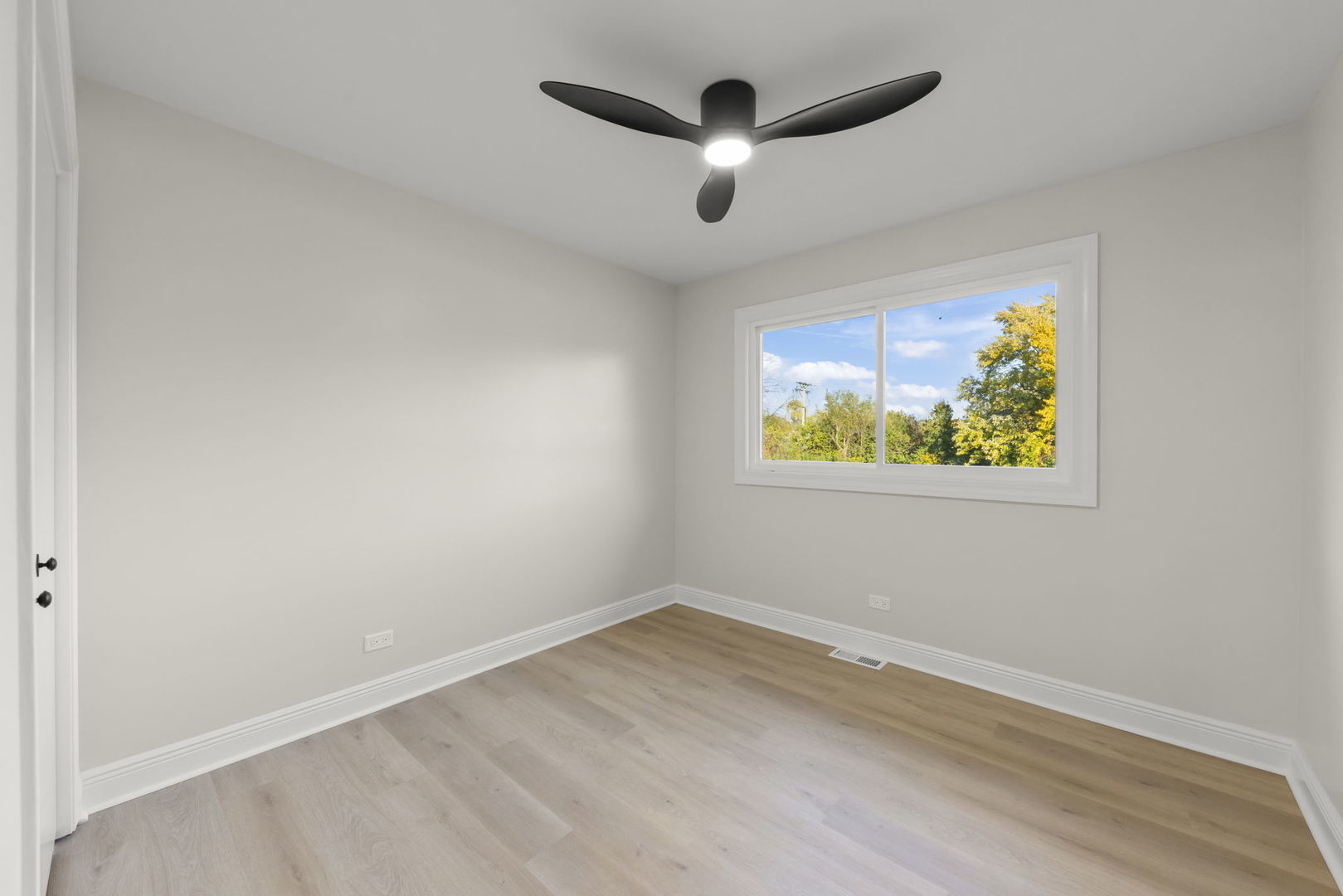 641 Highview Avenue Addison, IL 60101 - Photo 14 of 36 an empty room with wooden floor and ceiling fan