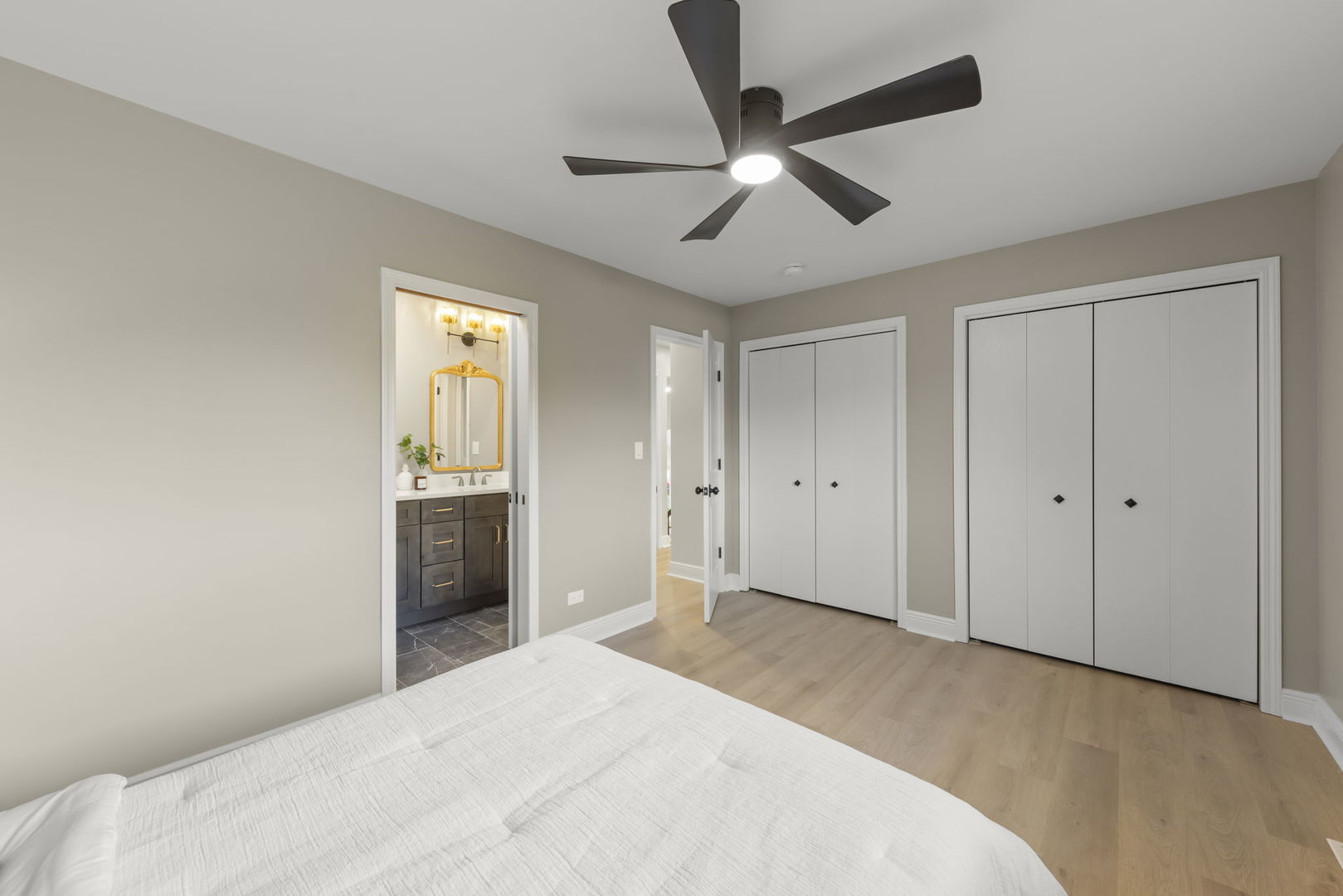 641 Highview Avenue Addison, IL 60101 - Photo 10 of 36 a bedroom with a large bed and a chandelier fan