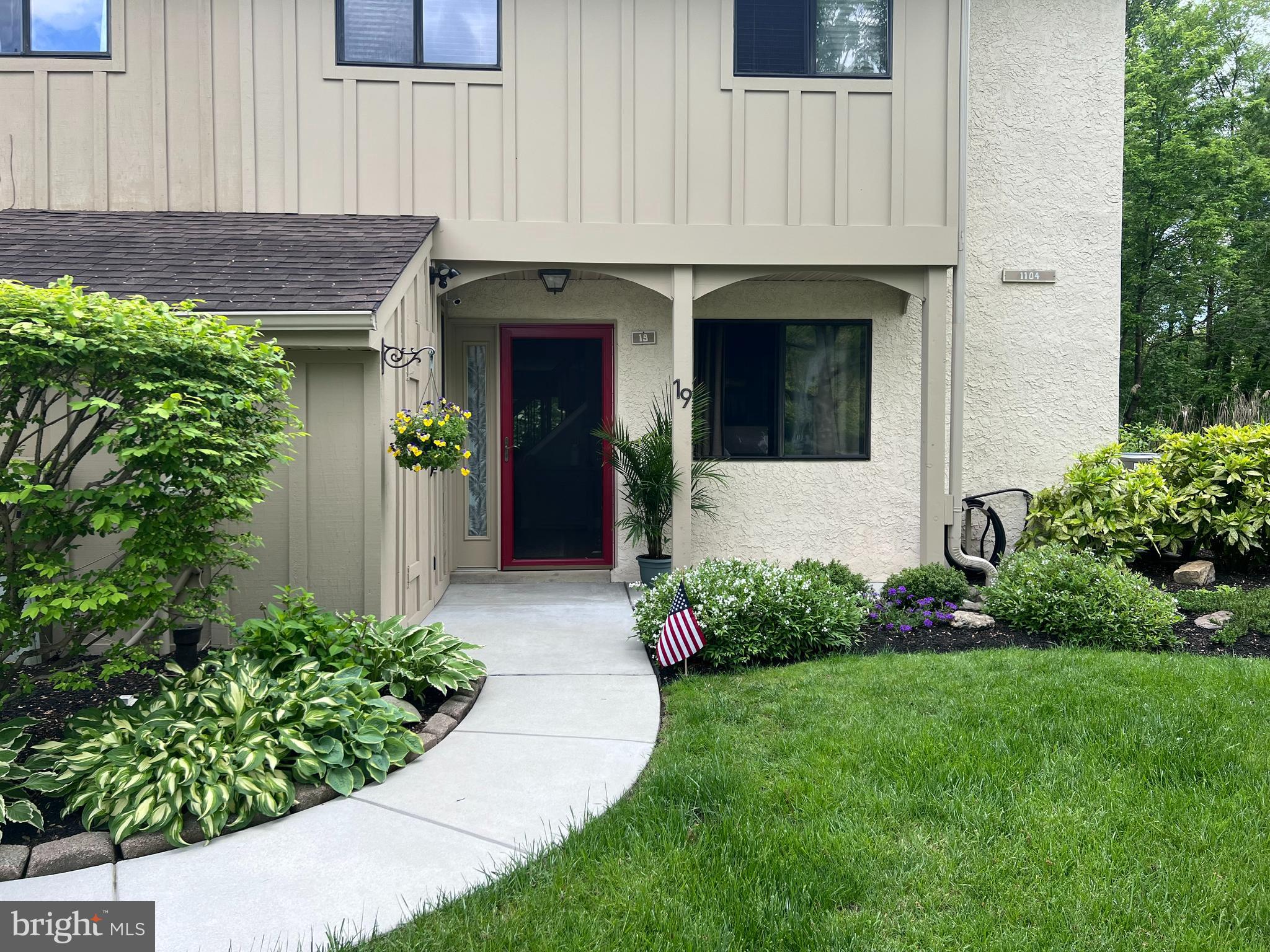 1104 Brinton Place Road, Unit 19 West Chester, PA 19380 - Photo 2 of 32 a view of a house with a small yard and plants