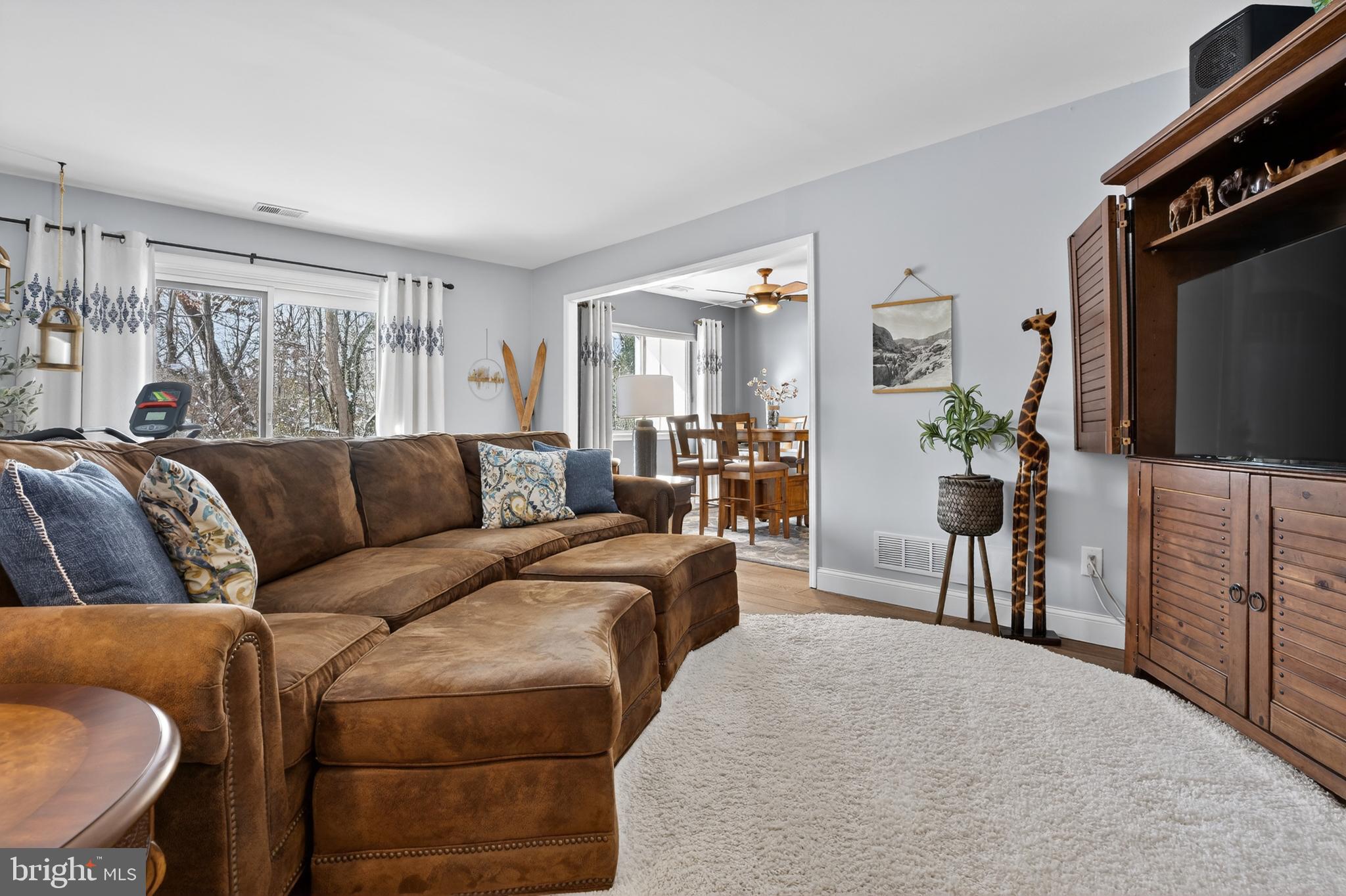 1104 Brinton Place Road, Unit 19 West Chester, PA 19380 - Photo 4 of 32 a living room with furniture a flat screen tv and a refrigerator