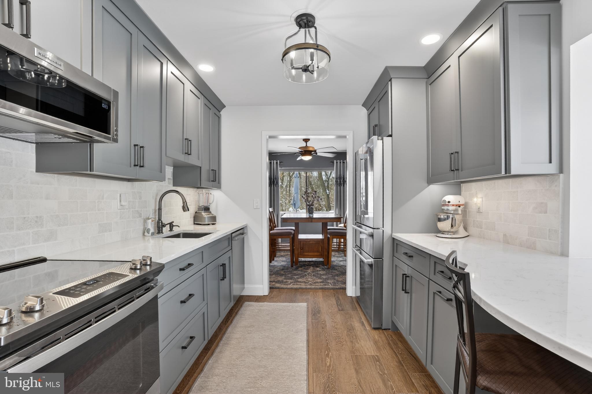 1104 Brinton Place Road, Unit 19 West Chester, PA 19380 - Photo 8 of 32 a kitchen with stainless steel appliances a sink stove and cabinets