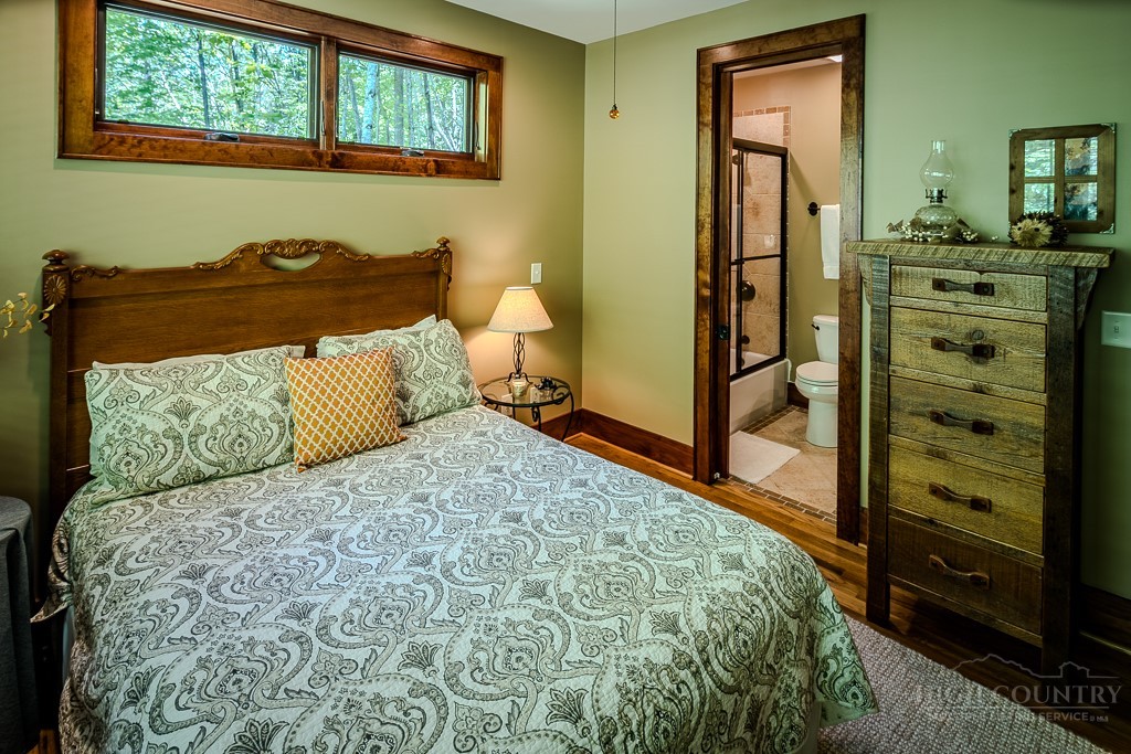 485 Woodlake Loop Road Elk Park, NC 28622 - Photo 21 of 44 a bedroom with a bed and a dresser