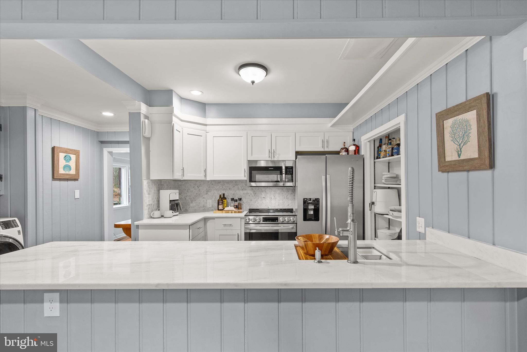 12107 Angler Road Ocean City, MD 21842 - Photo 13 of 106 a kitchen with stainless steel appliances a refrigerator sink and cabinets