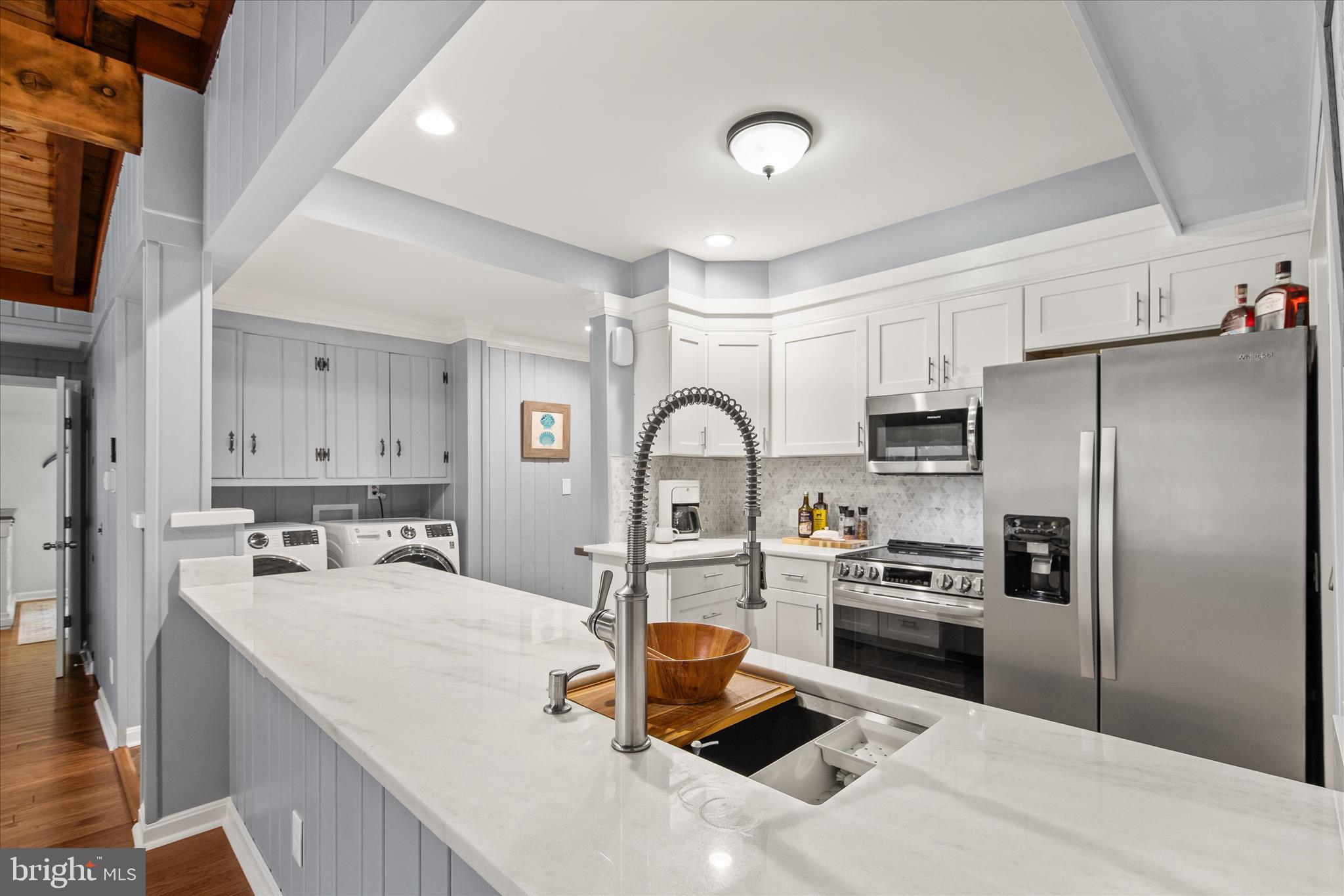12107 Angler Road Ocean City, MD 21842 - Photo 15 of 106 a kitchen with stainless steel appliances granite countertop a sink a stove and a refrigerator