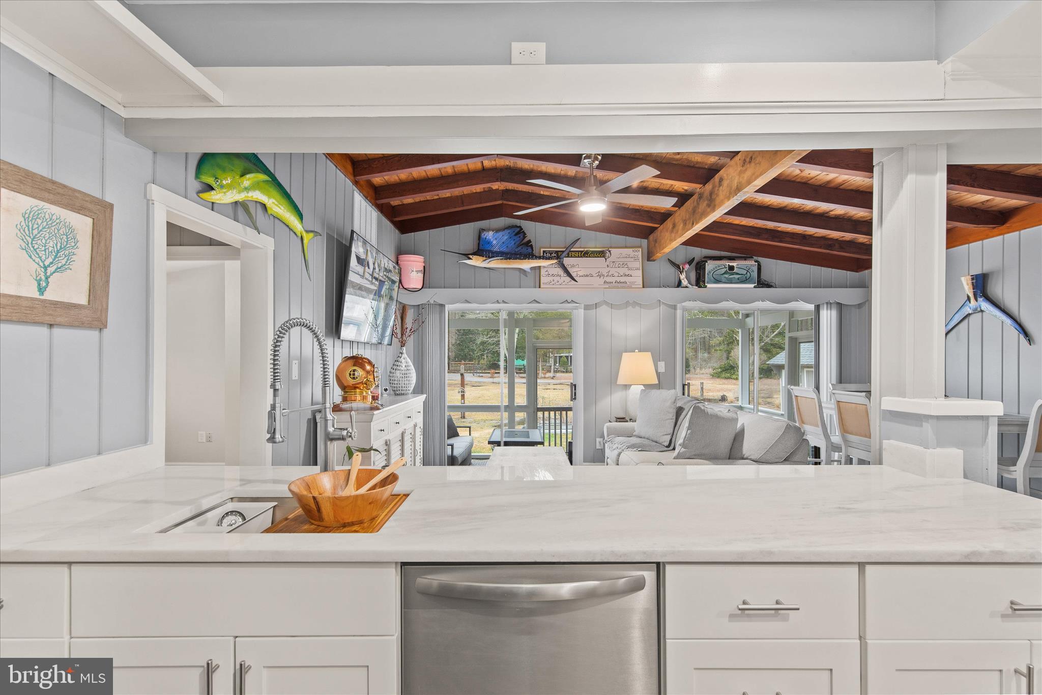 12107 Angler Road Ocean City, MD 21842 - Photo 17 of 106 a bathroom with a sink and a large mirror next to a white cabinet