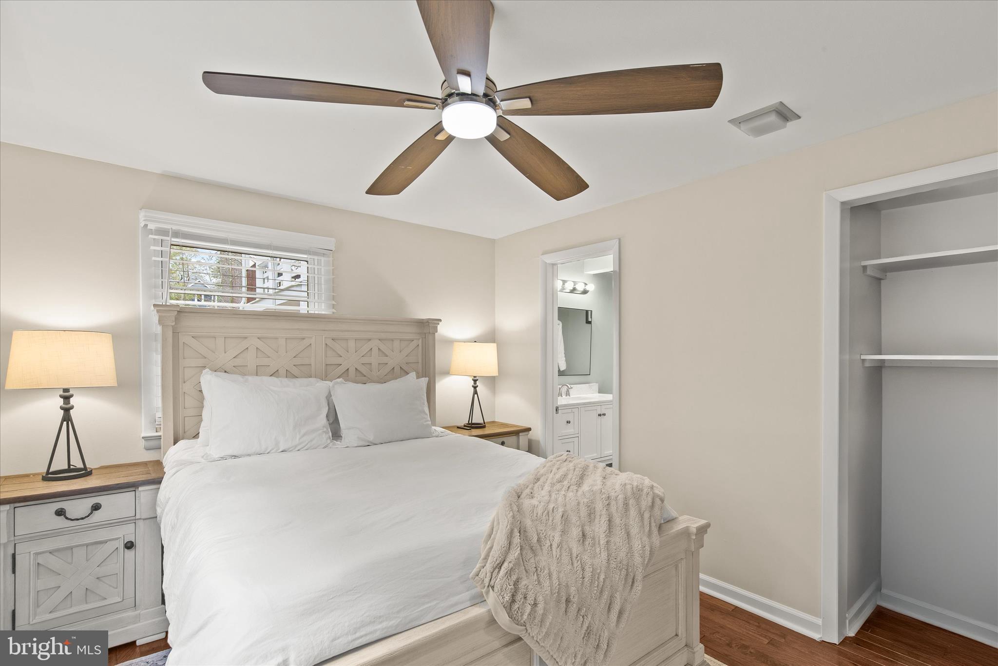 12107 Angler Road Ocean City, MD 21842 - Photo 36 of 106 a bedroom with a bed and a chandelier