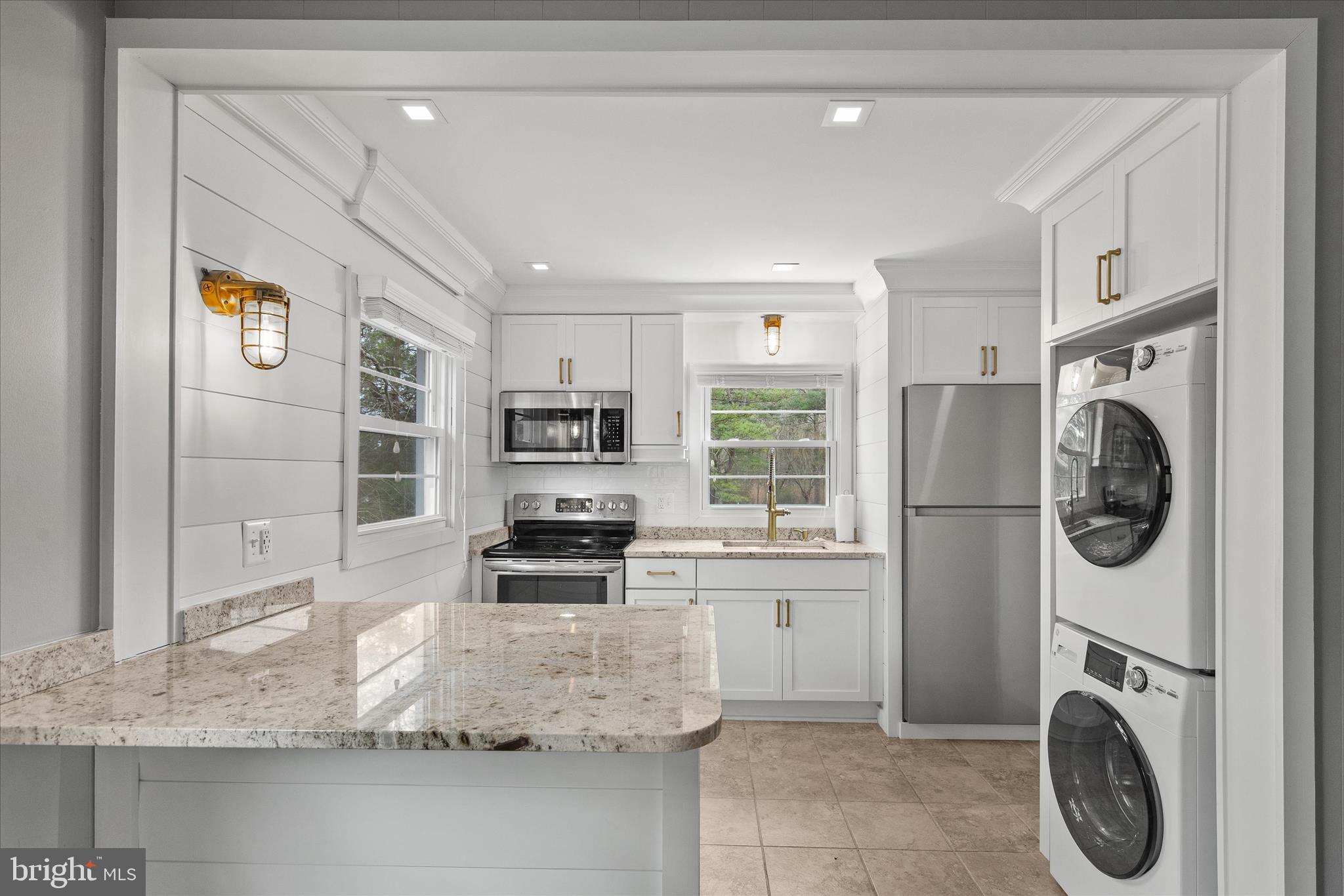 12107 Angler Road Ocean City, MD 21842 - Photo 61 of 106 a kitchen with granite countertop a sink a stove and a refrigerator