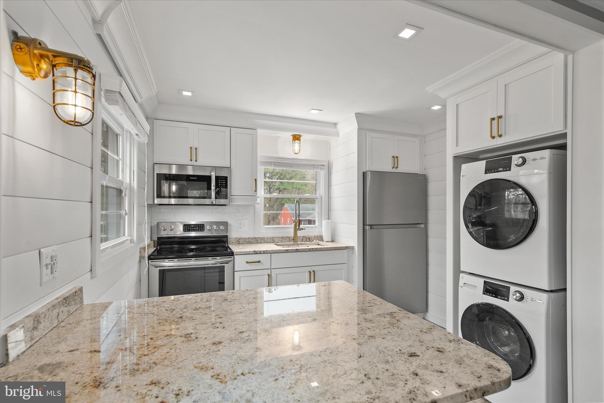 12107 Angler Road Ocean City, MD 21842 - Photo 62 of 106 a kitchen with stainless steel appliances granite countertop a refrigerator sink stove and wooden floor