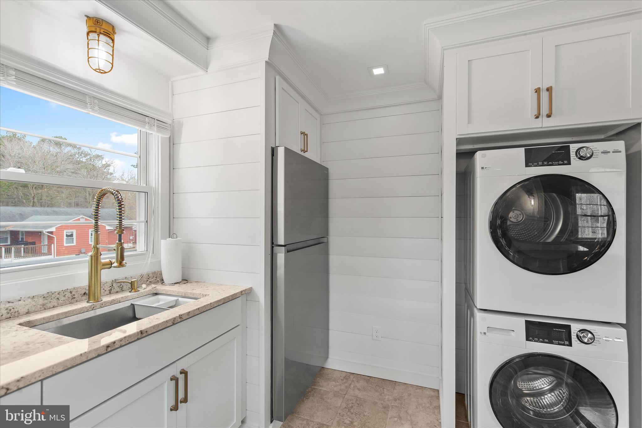 12107 Angler Road Ocean City, MD 21842 - Photo 68 of 106 a kitchen with a sink and a washer dryer