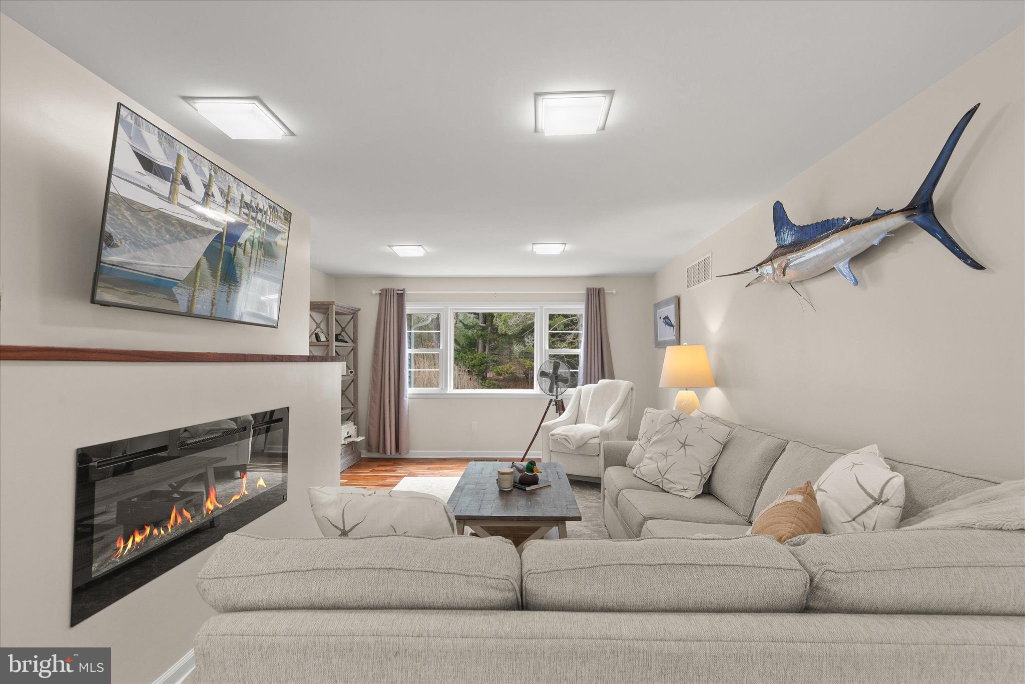 12107 Angler Road Ocean City, MD 21842 - Photo 7 of 106 a living room with furniture or couch and a fireplace