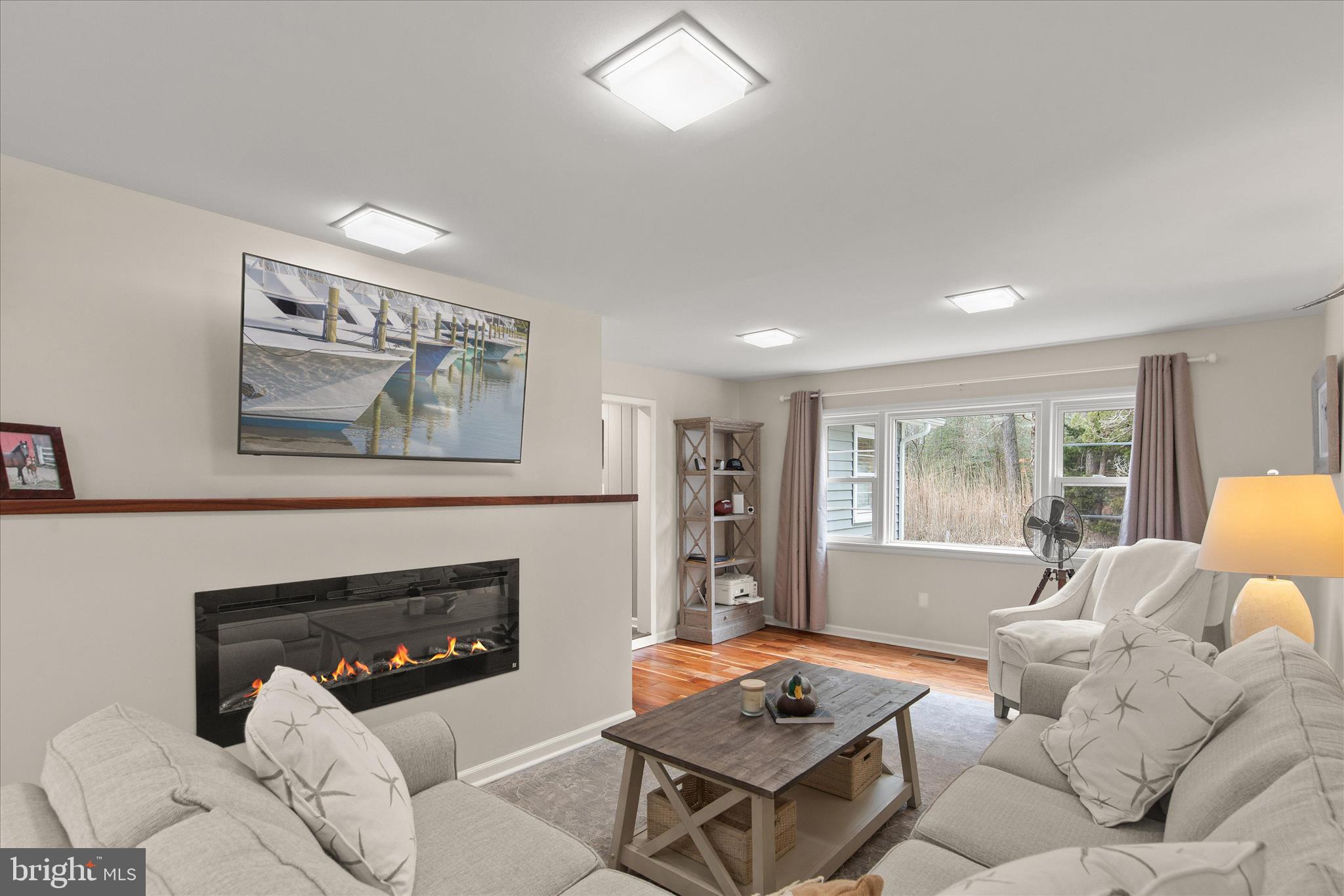 12107 Angler Road Ocean City, MD 21842 - Photo 8 of 106 a living room with furniture and a fireplace