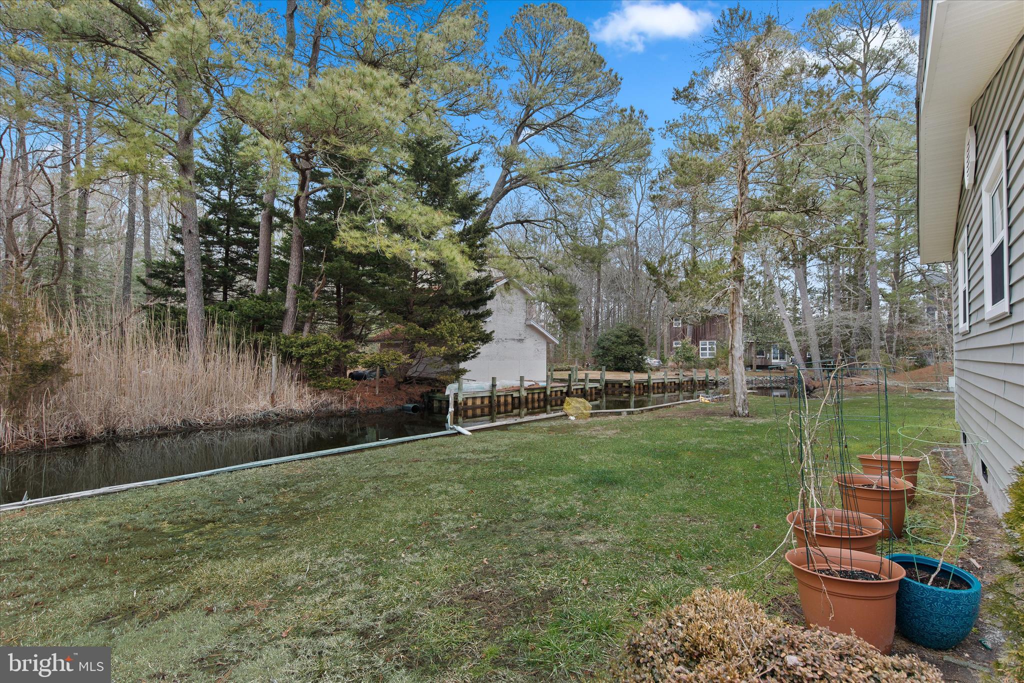 12107 Angler Road Ocean City, MD 21842 - Photo 84 of 106 a backyard of a house with table and chairs