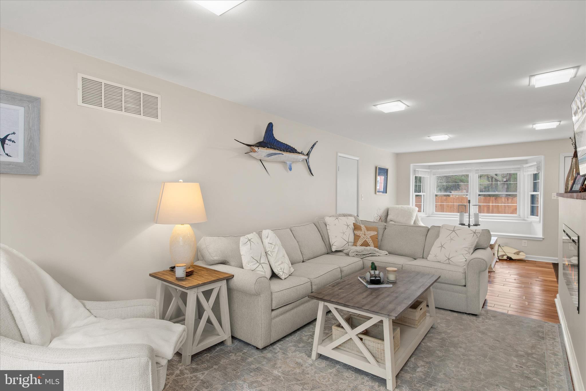 12107 Angler Road Ocean City, MD 21842 - Photo 9 of 106 a living room with furniture and a lamp