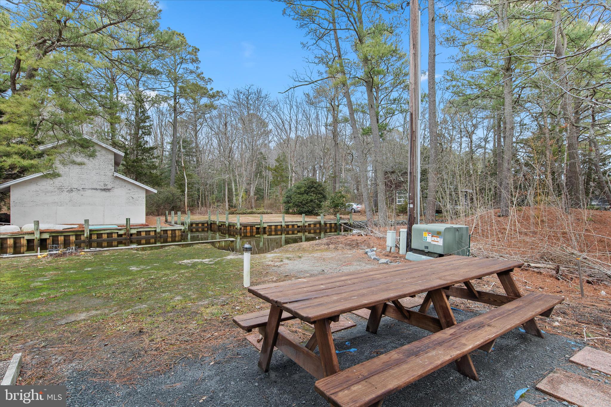 12107 Angler Road Ocean City, MD 21842 - Photo 91 of 106 a view of a wooden dinning table and chairs in the patio