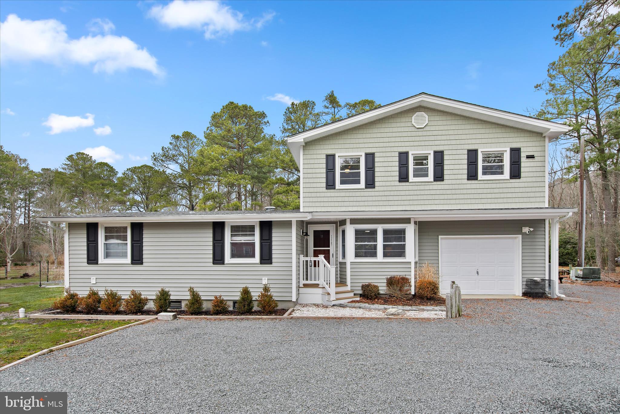 12107 Angler Road Ocean City, MD 21842 - Photo 97 of 106 a front view of a house with a yard and garage