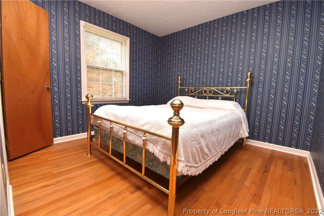 5401 Chesapeake Road Fayetteville, NC 28311 - Photo 11 of 17 a bed sitting in a bedroom next to a window