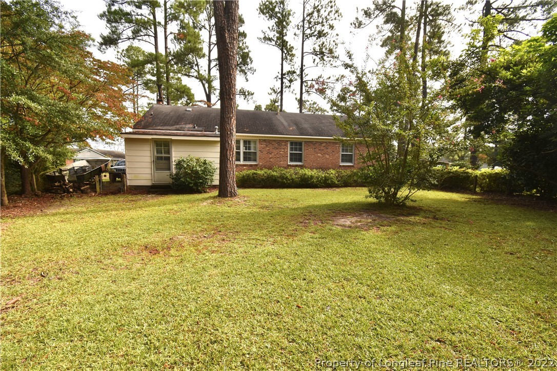 5401 Chesapeake Road Fayetteville, NC 28311 - Photo 16 of 17 a view of a house with a yard and large trees