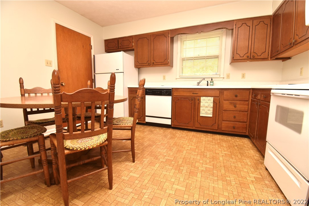 5401 Chesapeake Road Fayetteville, NC 28311 - Photo 7 of 17 a kitchen with granite countertop a stove a sink and a microwave