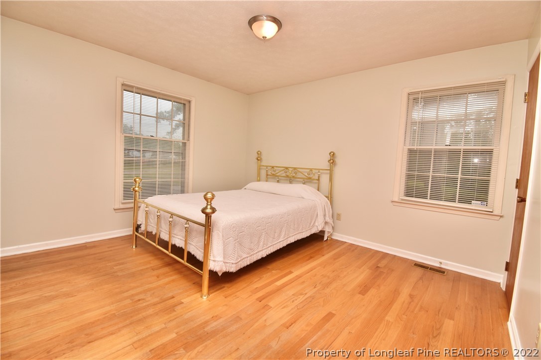5401 Chesapeake Road Fayetteville, NC 28311 - Photo 8 of 17 a bed sitting in a room next to a window
