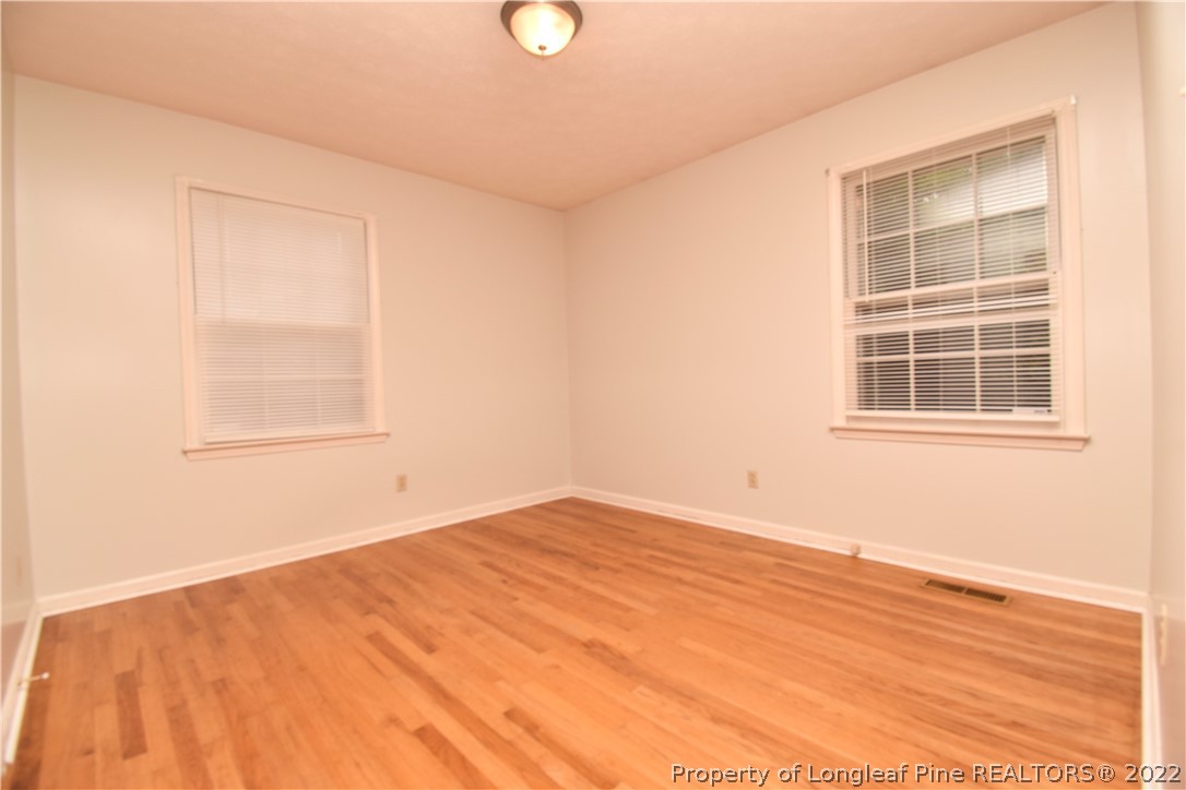 5401 Chesapeake Road Fayetteville, NC 28311 - Photo 10 of 17 a view of empty room with wooden floor and fan