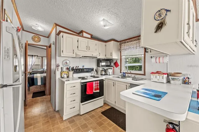a kitchen with cabinets and a stove top oven