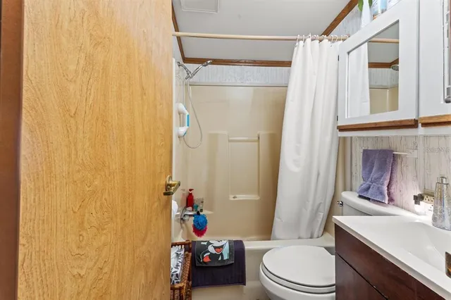 a bathroom with a toilet a sink and a shower