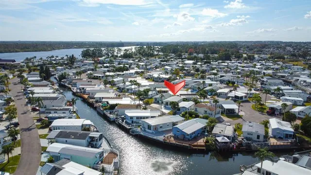 an aerial view of a city with lots of residential buildings and ocean view in back