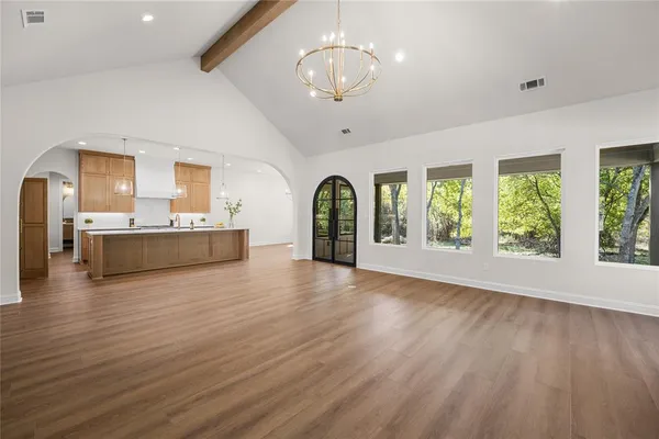 a living room with stainless steel appliances granite countertop furniture and a large window