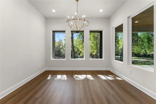 a kitchen with a sink a counter space and wooden floor