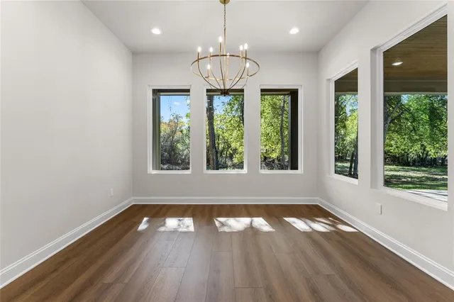 a kitchen with a sink a counter space and wooden floor