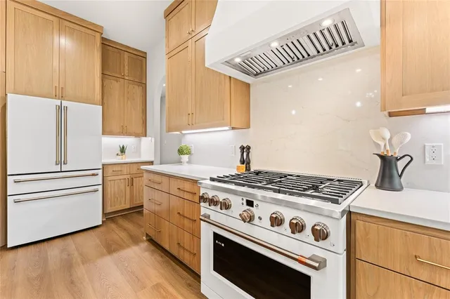 a kitchen with stainless steel appliances a refrigerator and cabinets