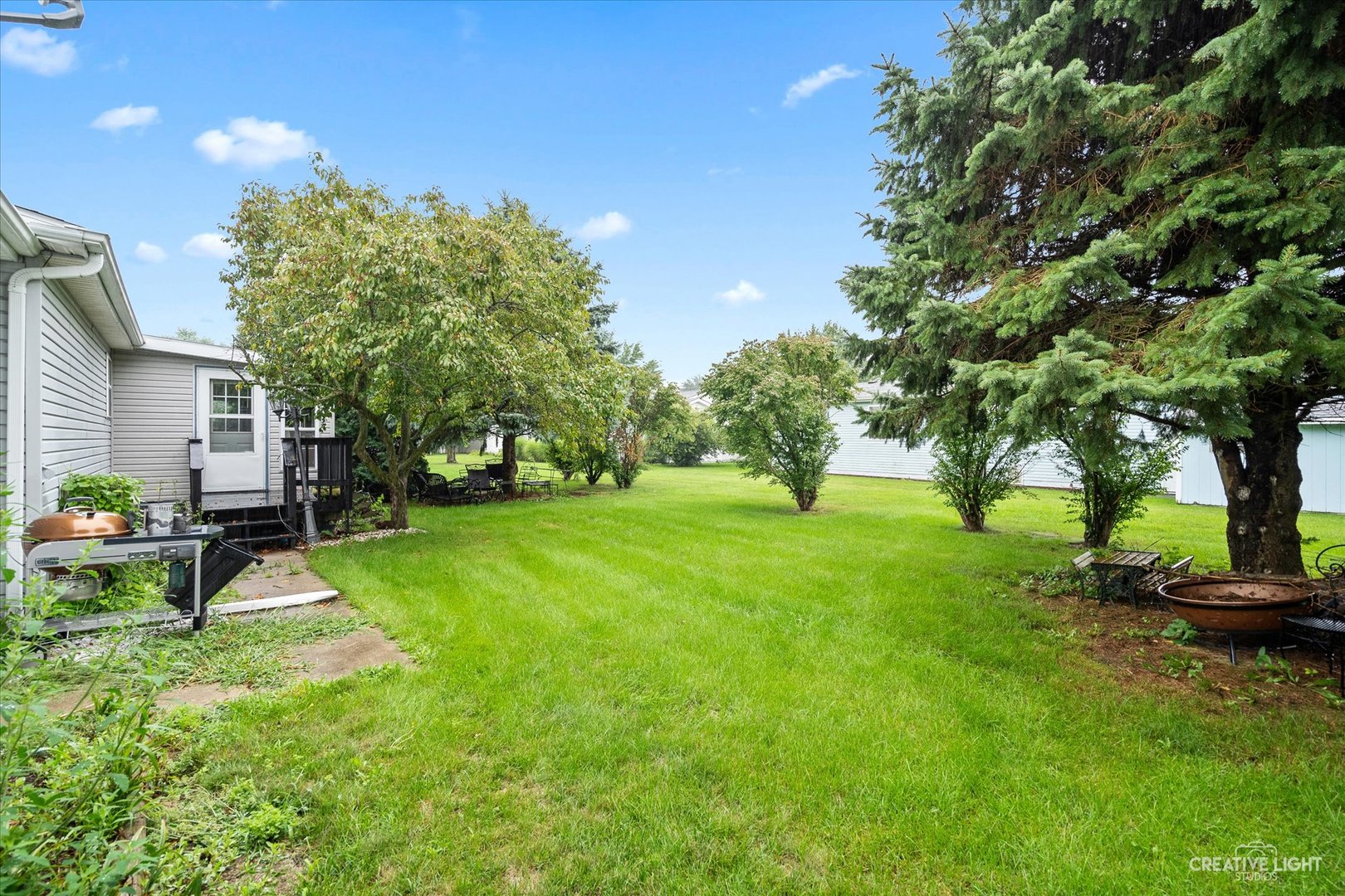 125 Cardinal Lane Sandwich, IL 60548 - Photo 3 of 21 a view of a backyard with a bench