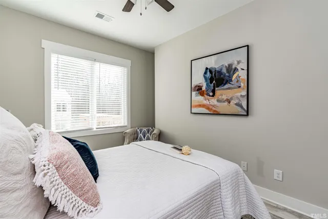 a bedroom with a bed and a painting on the wall