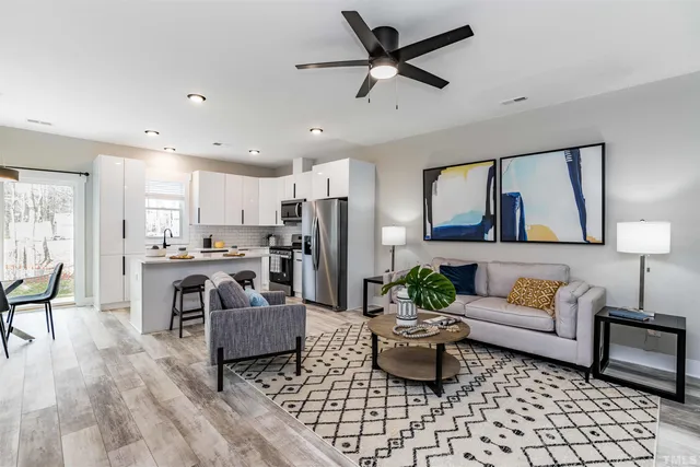 a living room with furniture and kitchen view