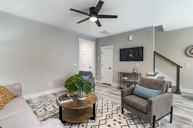 a living room with furniture and a flat screen tv