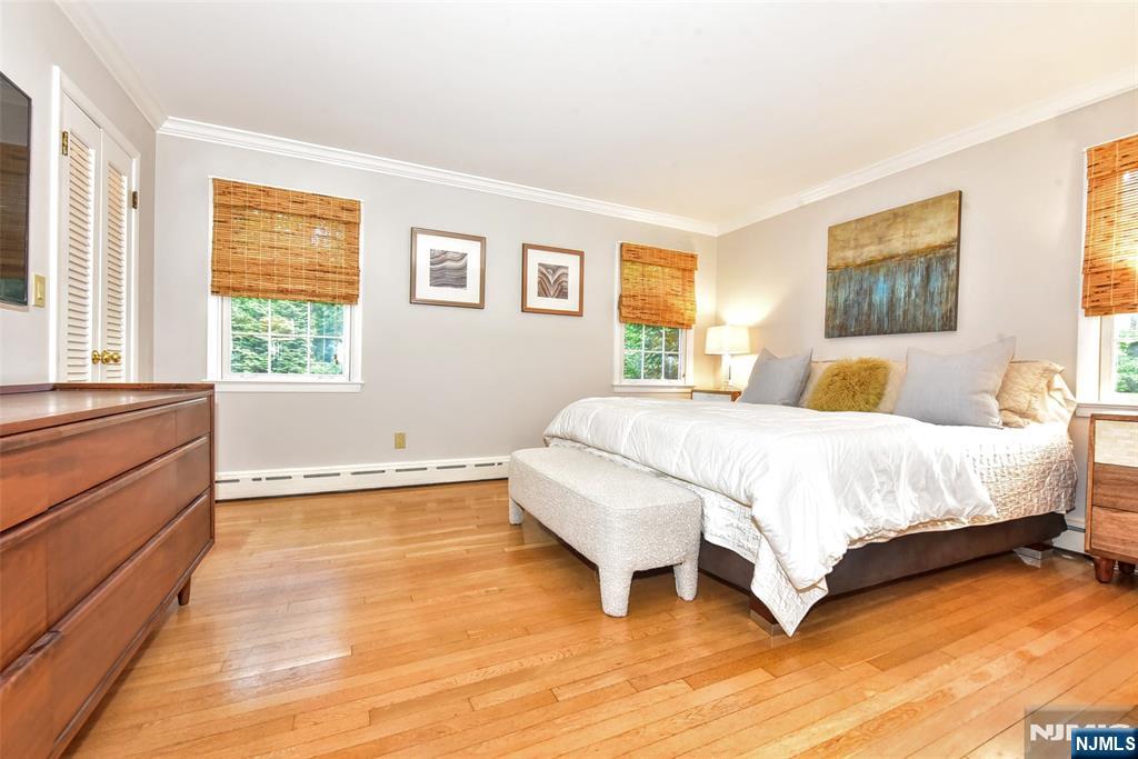 60 Dimmig Road Upper Saddle River, NJ 07458 - Photo 25 of 40 a bedroom with a bed and wooden floor next to a window