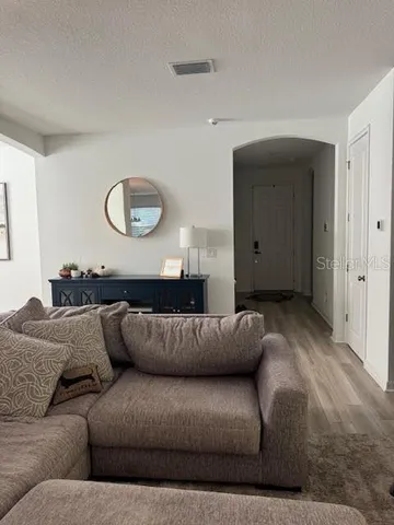a living room with a couch and a window