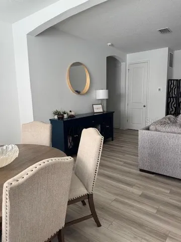 a living room with furniture and a mirror