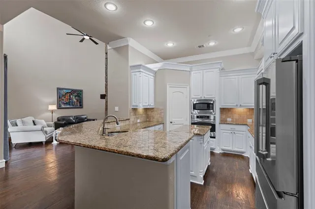 a kitchen with sink refrigerator and microwave