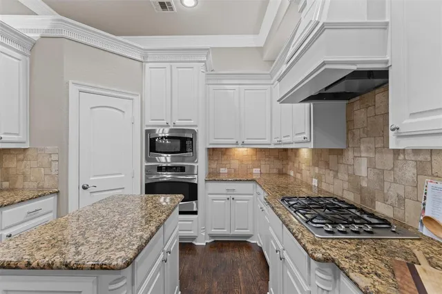 a kitchen with granite countertop a stove and a refrigerator