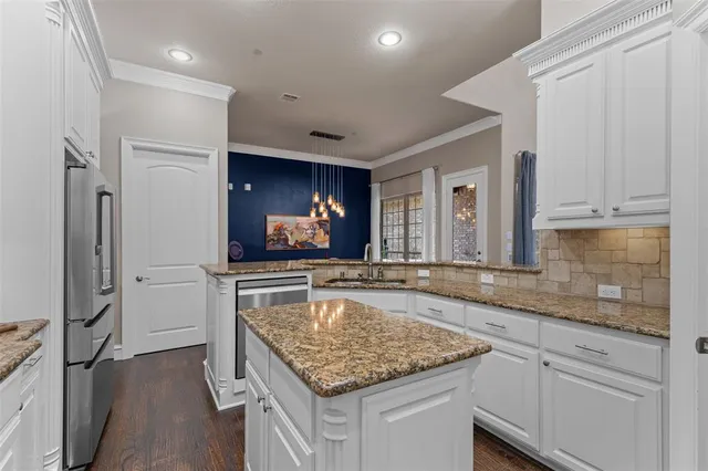 a kitchen with sink stove and refrigerator
