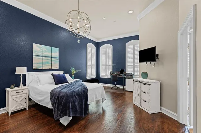 a bedroom with bed and wooden floor