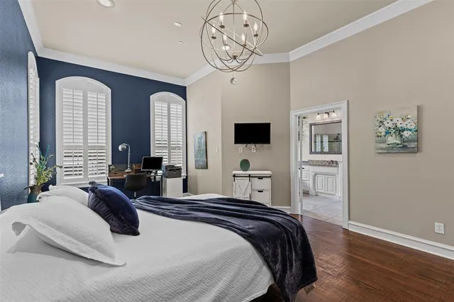 a spacious bedroom with a bed a mirror and a window