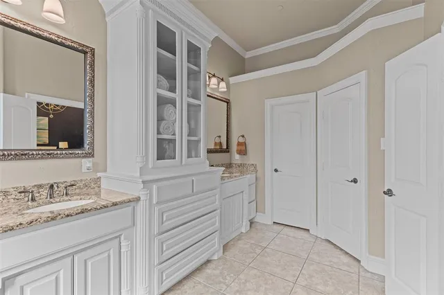 a bathroom with a granite countertop sink mirror and