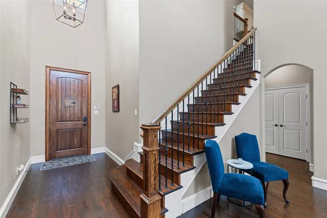 a view of entryway and hall with wooden floor