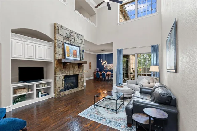 a living room with furniture a fireplace and a flat screen tv