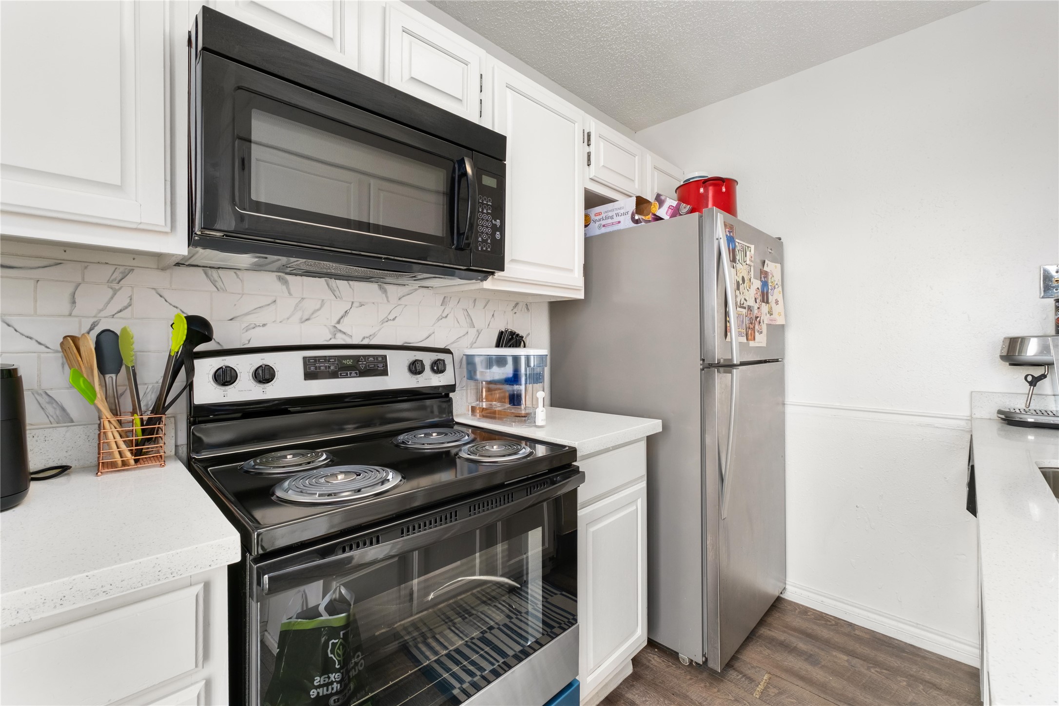 2409 Leon Street, Unit 307 Austin, TX 78705 - Photo 10 of 23 a kitchen with a stove and a microwave