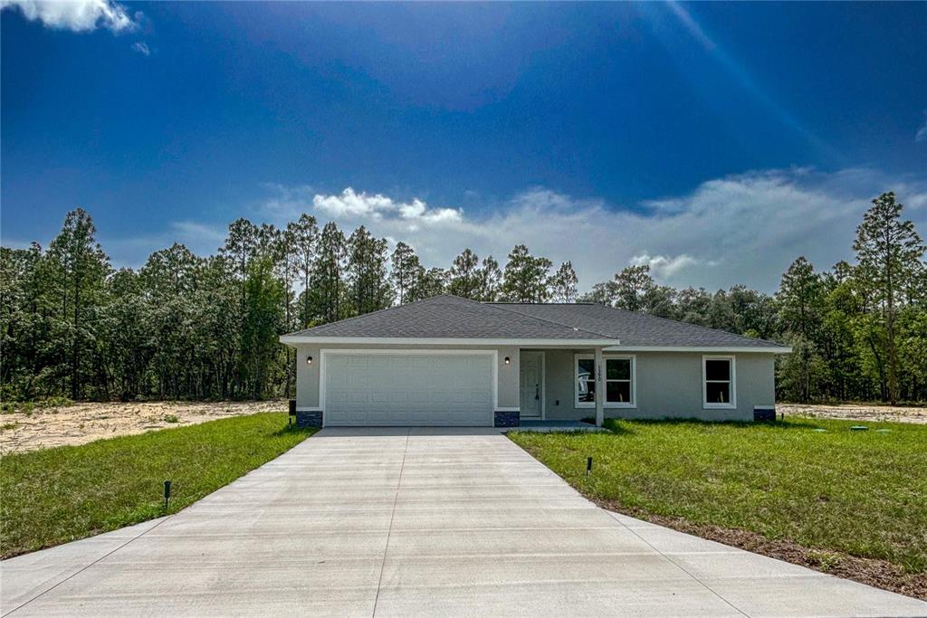 1390 Southwest Obee Ridge Road Dunnellon, FL 34431 - Photo 1 of 1 a front view of a house with a garden